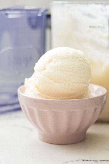 Scoop of high-protein vanilla ice cream in a pink bowl