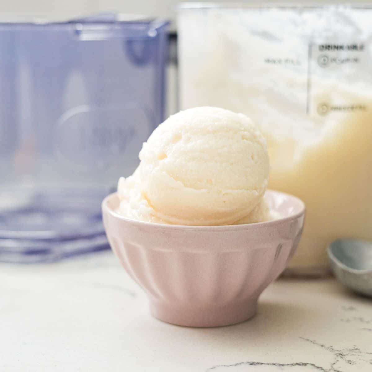 Scoop of high-protein vanilla ice cream in a pink bowl